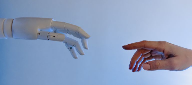 Robot hand almost touching human hand