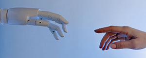 Robot hand almost touching human hand