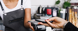 Person paying with their phone at a coffee shop